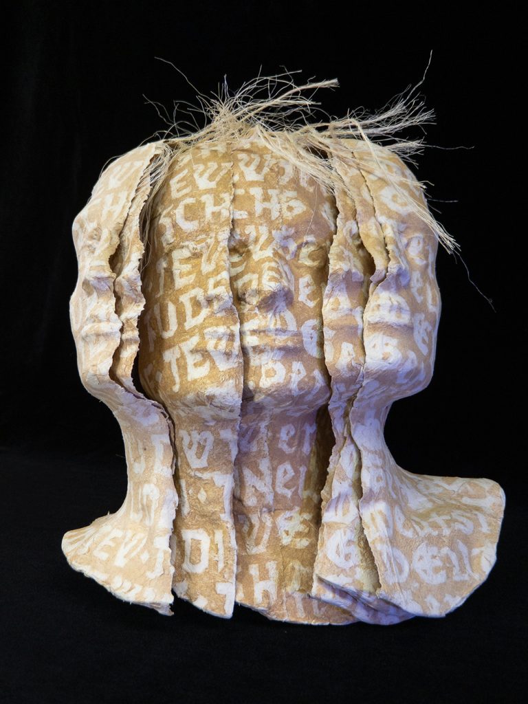 German/Jew: An artist's book by Karen Baldner composed of multiple paper casts of the artist's head